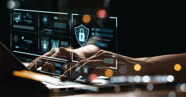 Imagem de um profissional digitando em um laptop, com elementos gráficos digitais sobrepostos, representando conceitos de cibersegurança, inteligência artificial (IA) e proteção de dados. Os gráficos incluem um escudo com um cadeado, campos de login e diversas interfaces digitais, simbolizando segurança da informação e autenticação online (Brasil, ciso, cso, segurança, cibersegurança, digital, phishing, funcionários, Parceria, banco)